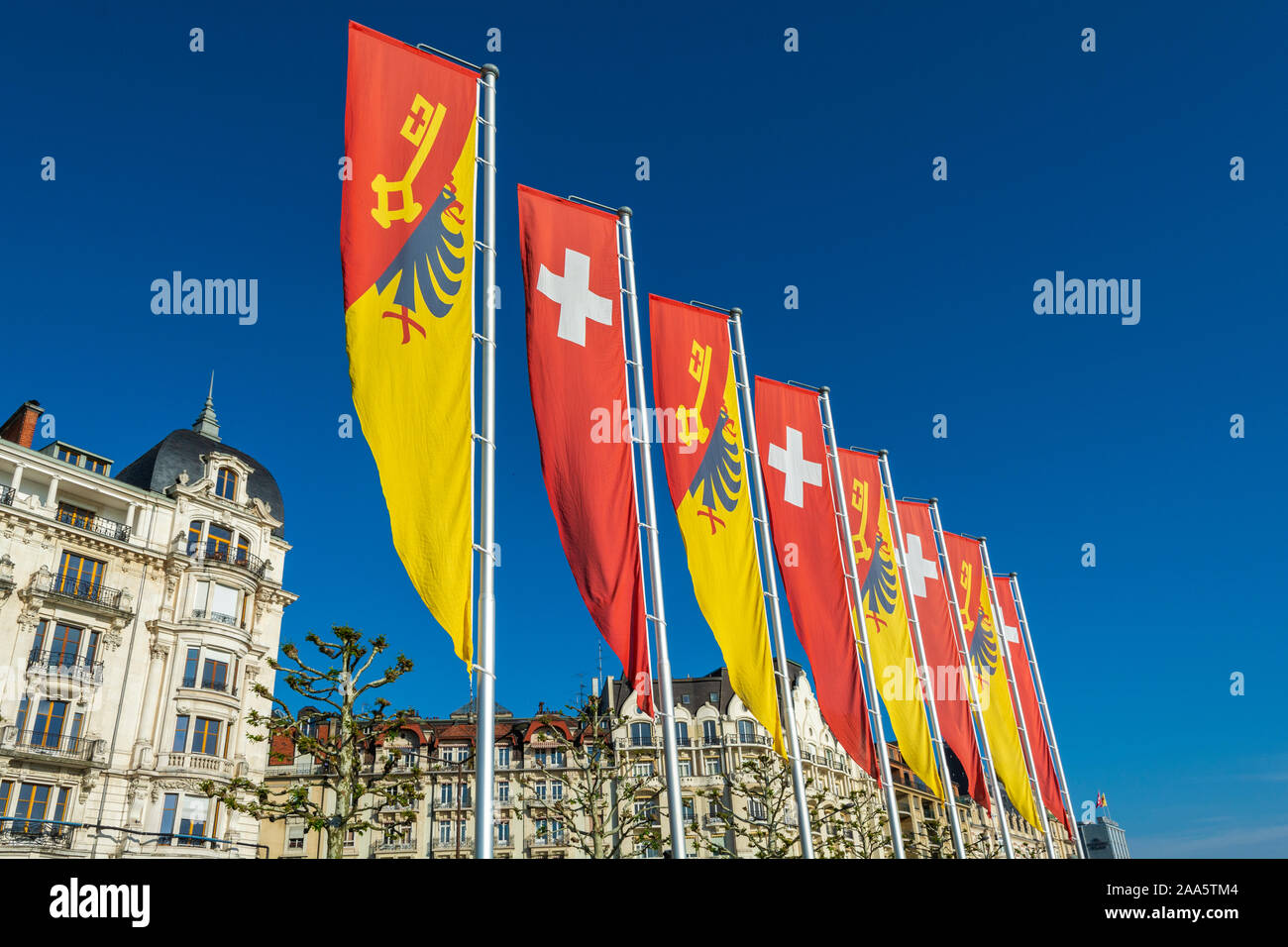 Switzerland, Geneva, Quai Woodrow Wilson, Geneva Canton and Swiss flag banners Stock Photo
