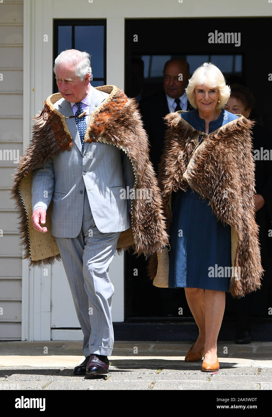 The Prince of Wales and the Duchess of Cornwall wear Maori cloaks, during their visit to Waitangi Treaty Grounds, the Bay of Islands, on the fourth day of the royal visit to New Zealand. Stock Photo