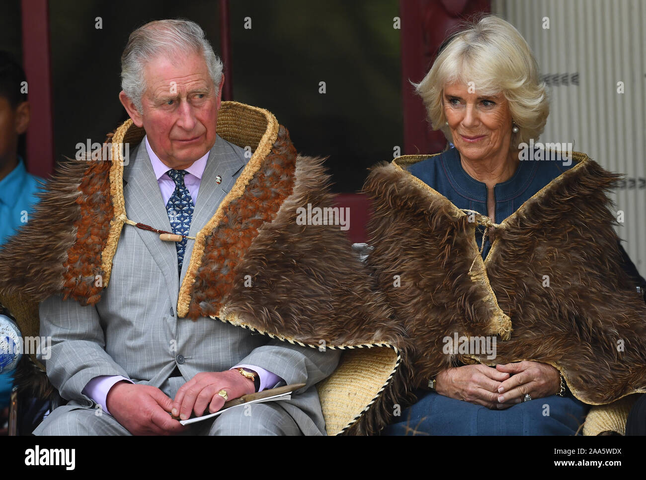 The Prince of Wales and the Duchess of Cornwall wear Maori cloaks, during their visit to Waitangi Treaty Grounds, the Bay of Islands, on the fourth day of the royal visit to New Zealand. Stock Photo