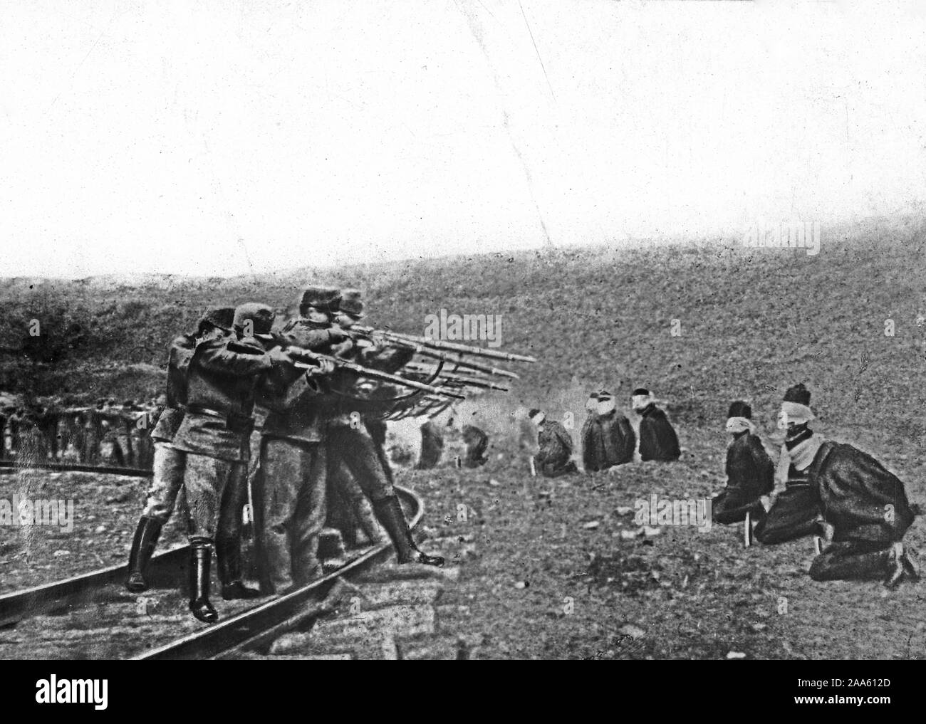 Austrian's Atrocities. Blindfolded and in kneeling position, patriotic Jugo-Slavs in Serbia near the Austrian lines were arranged in a semi-circle and ruthlessly shot at a commandf ca. 1917-1918 Stock Photo