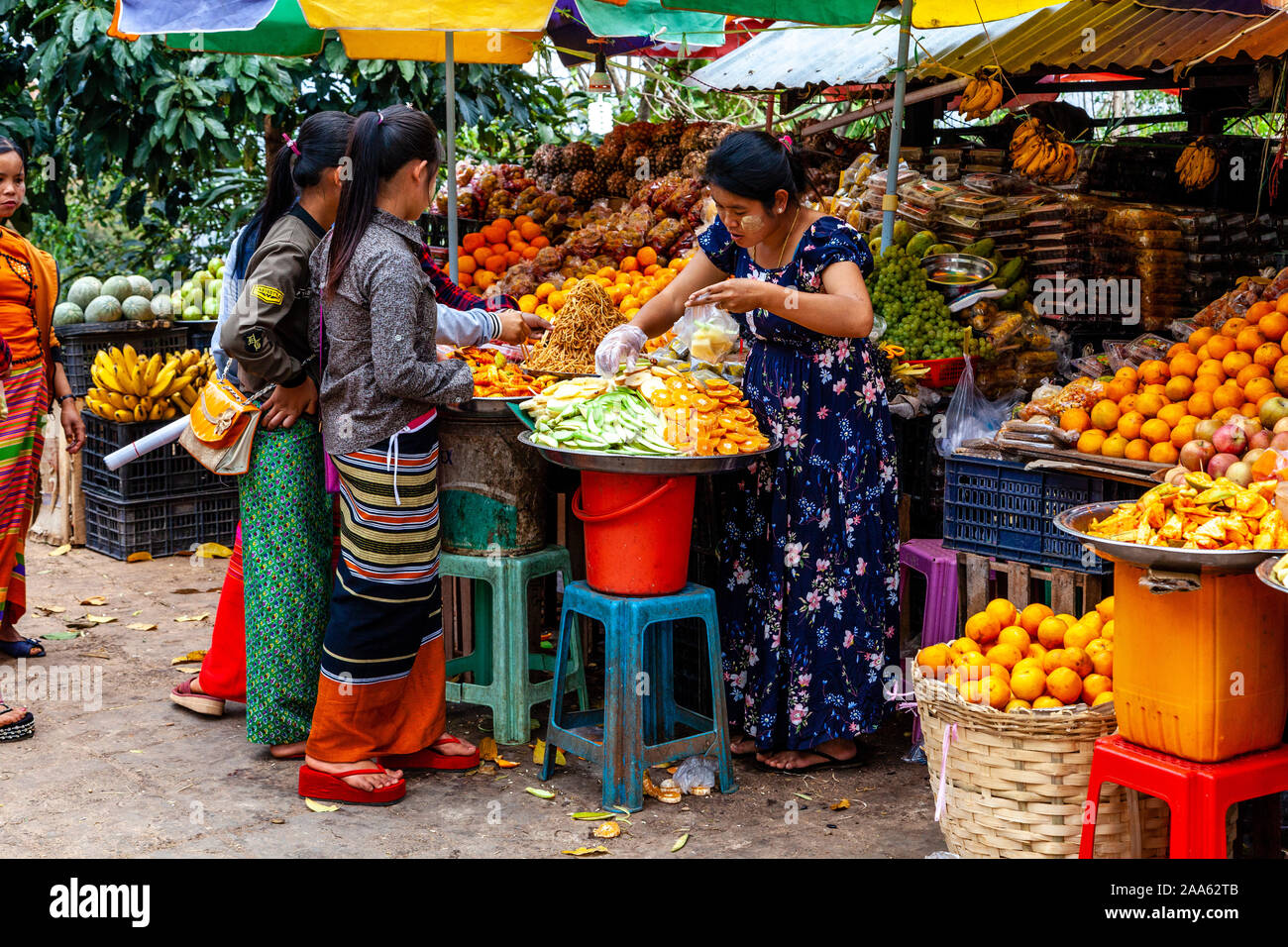 Young Women Buying Fruit In The Market, Pindaya, Shan State, Myanmar. Stock Photo