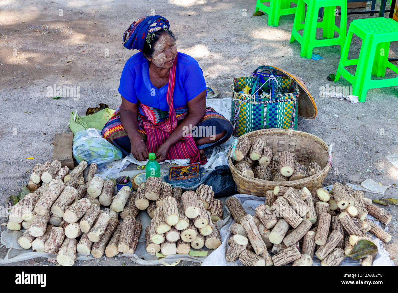 An Ethnic Minority Woman Selling Logs/Wood In The Market, Pindaya, Shan State, Myanmar. Stock Photo