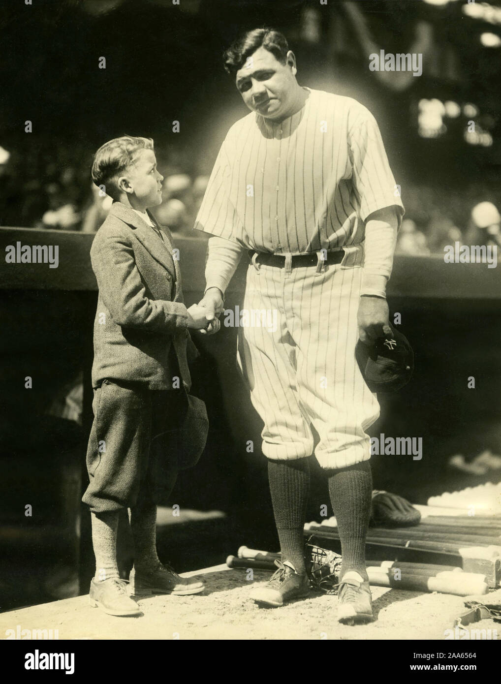Legendary New York Yankee baseball player Babe Ruth poses for a photo with a young boy. Stock Photo