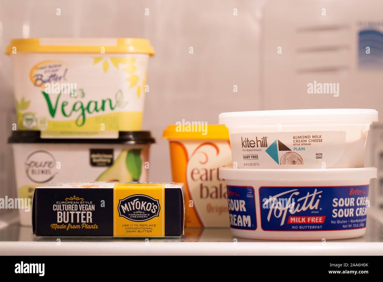 Vegan non-dairy products on a refrigerator shelf. Stock Photo