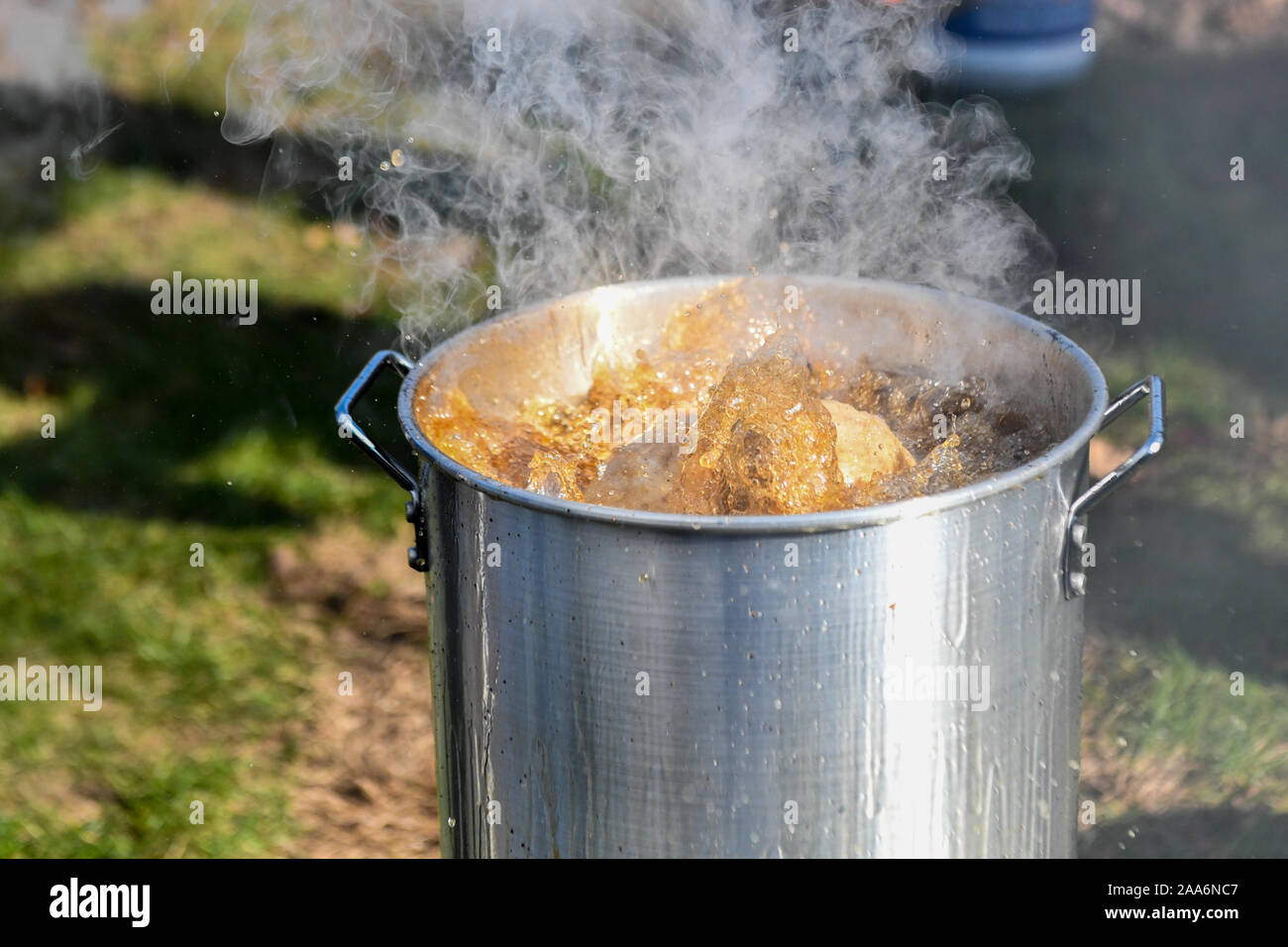 Boiling oil in a deep frier - hot oil - bubbling oil - steaming hot deep frier - boiling deep frier Stock Photo