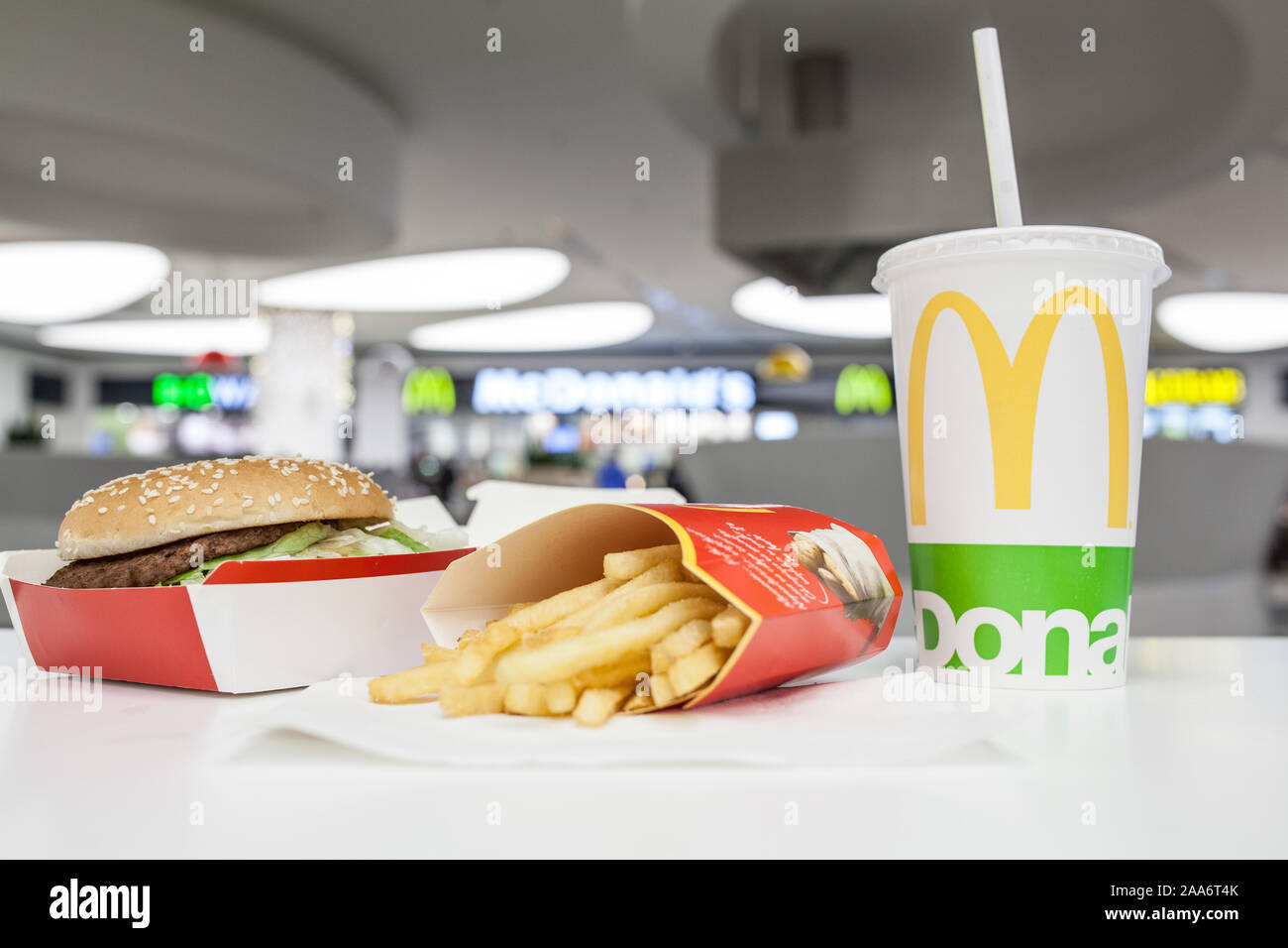 McDonald's Big Mac 100% pure beef sandwiched with refreshing Coca-Cola Coke, big yellow McDonald's M sign, logo on cup, French fries Stock Photo