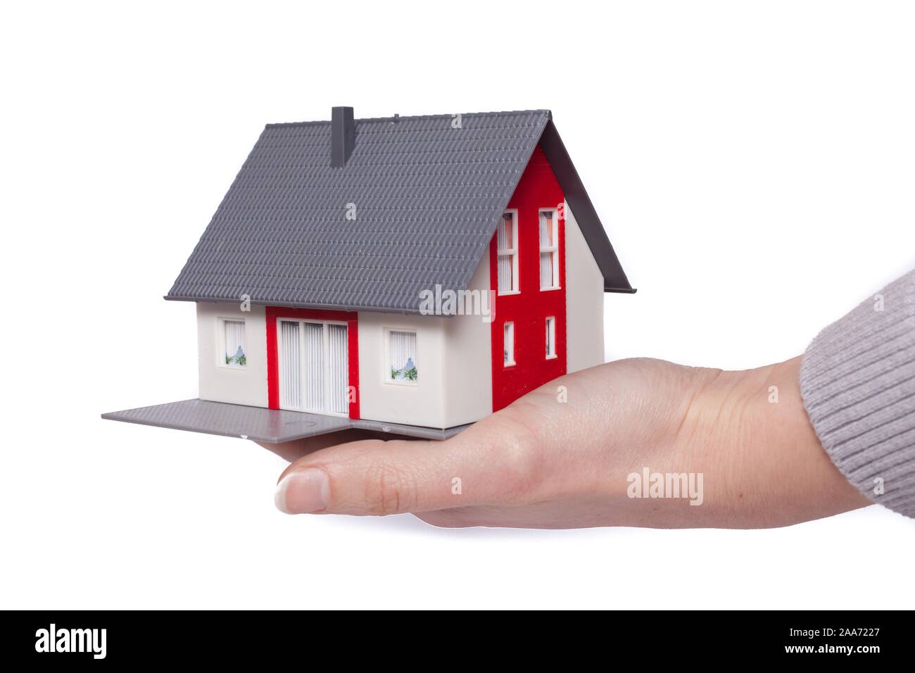 A toy model house laid on a hand, symbol picture own home, real estate, Belgium Stock Photo