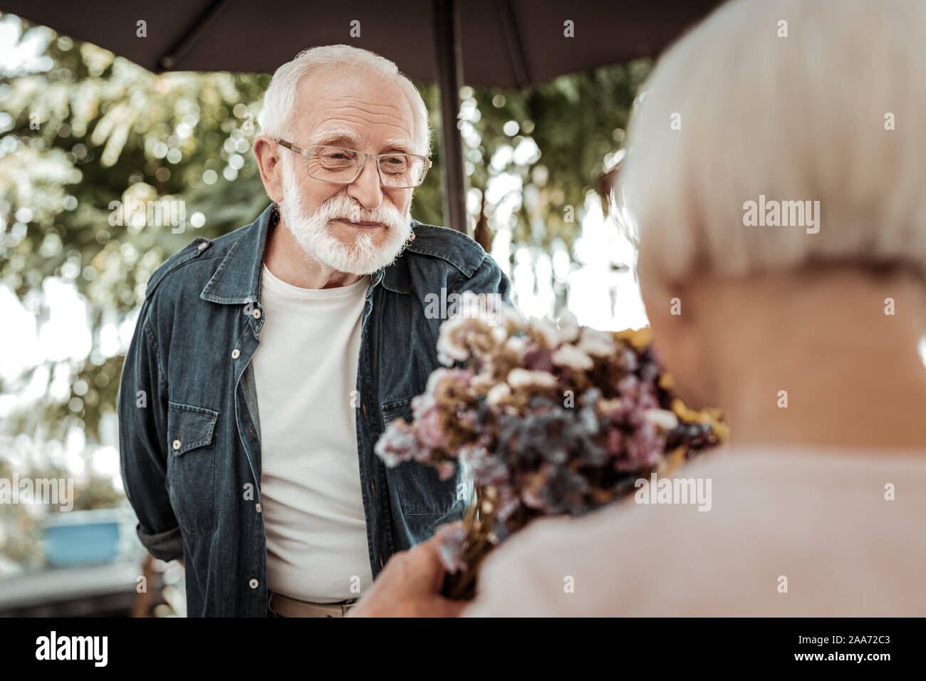 Positive nice aged man having a date Stock Photo