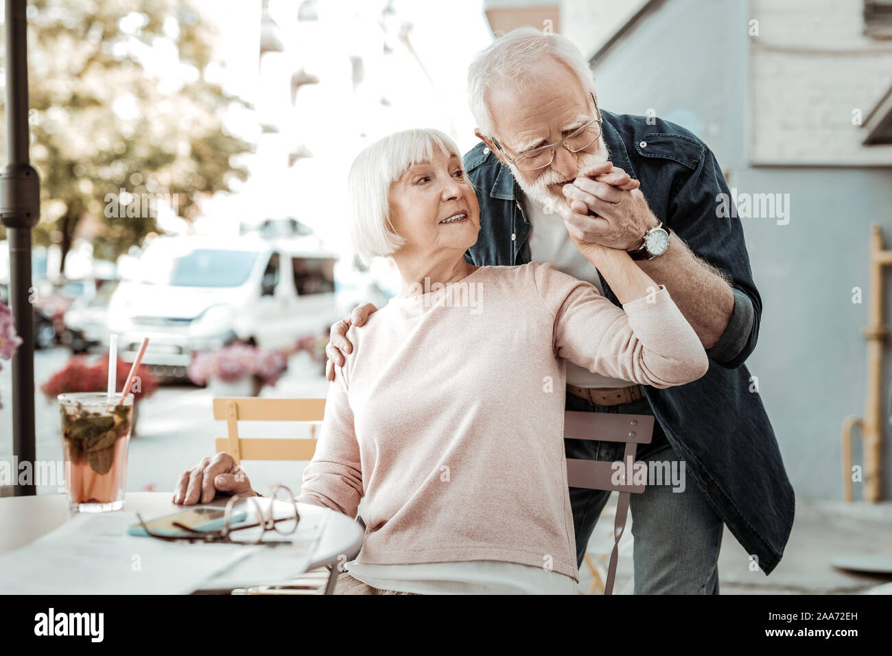 Nice aged man kissing his wifes hand Stock Photo