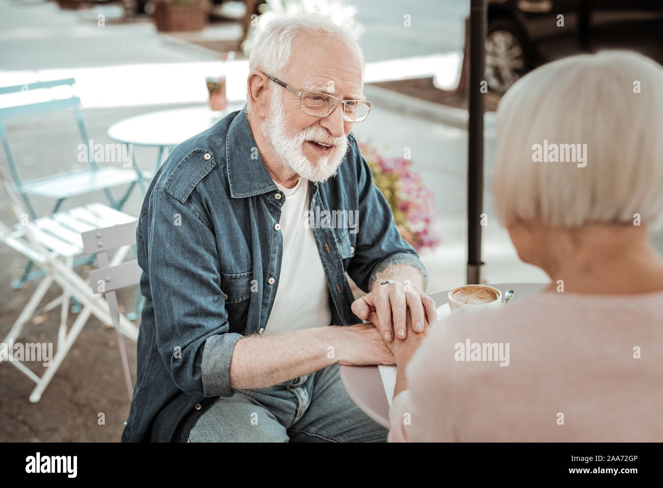 Nice aged man looking at his beloved wife Stock Photo