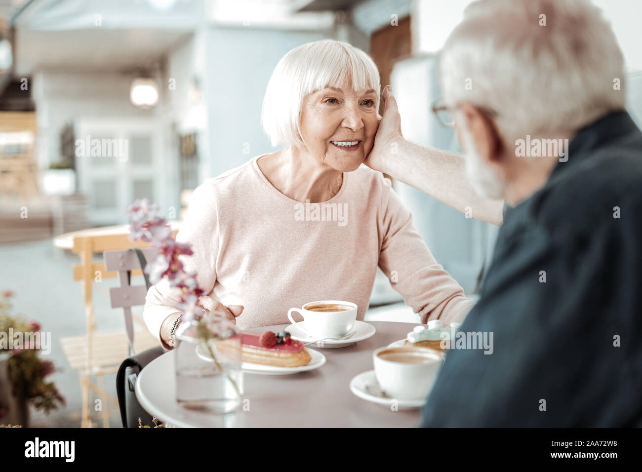 Nice aged man touching his wifes cheek Stock Photo