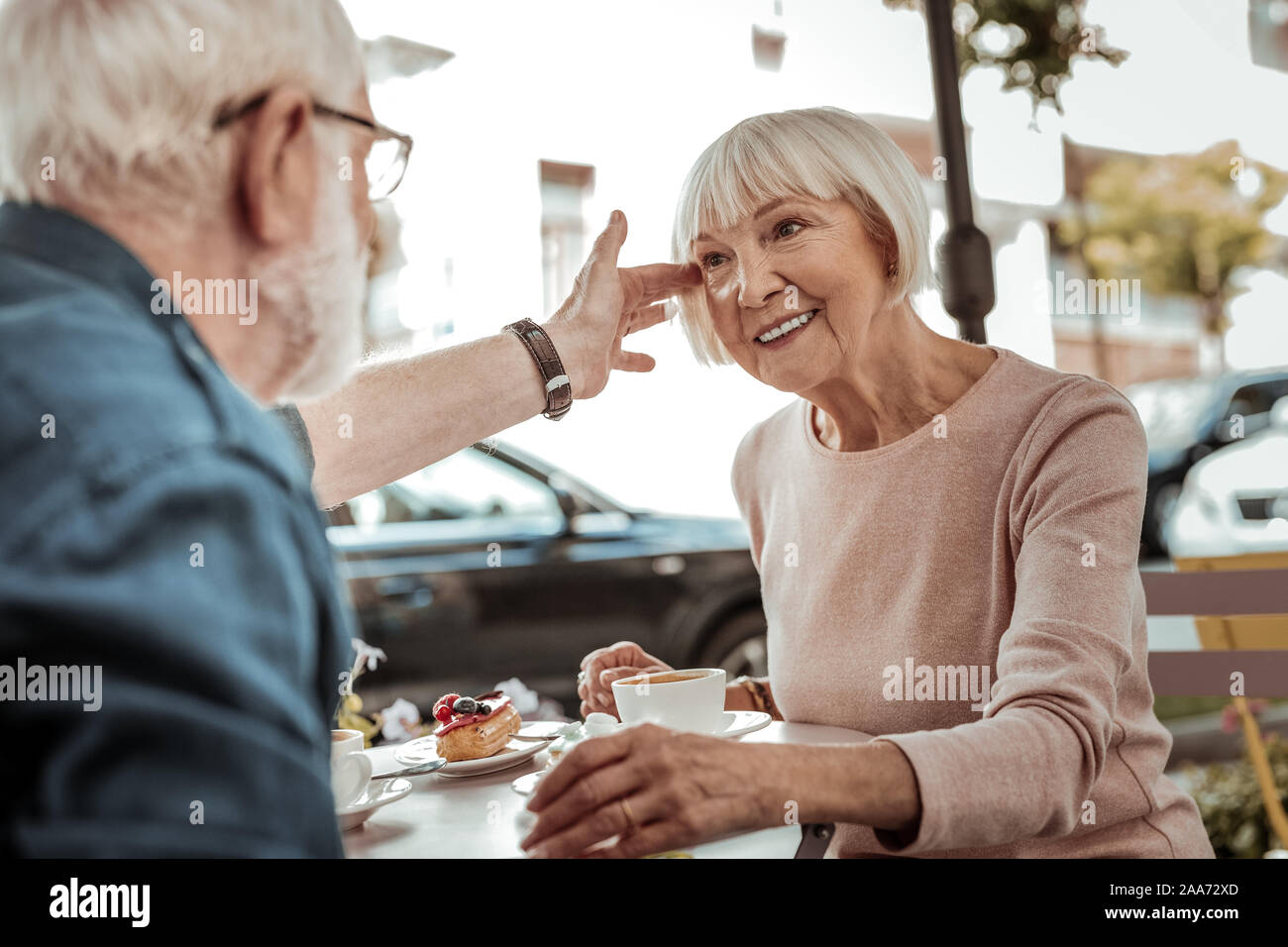 Nice aged man touching his wifes hair Stock Photo