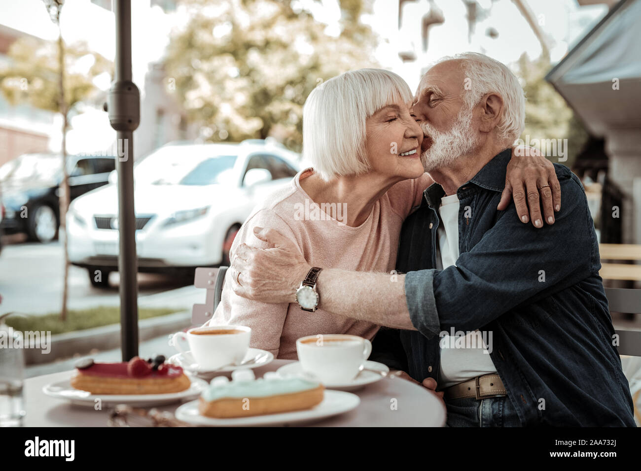 Nice grey haired man kissing his wife Stock Photo