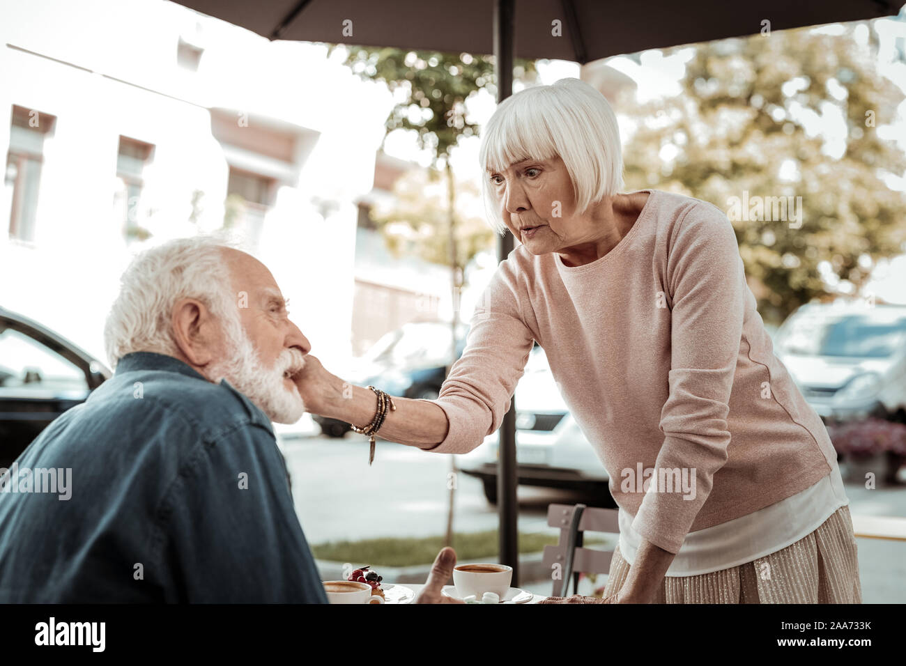 Nice aged woman touching her husband cheek Stock Photo
