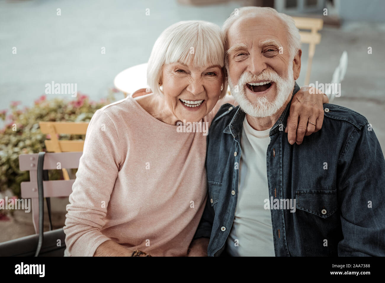 Positive aged woman sitting with her husband Stock Photo
