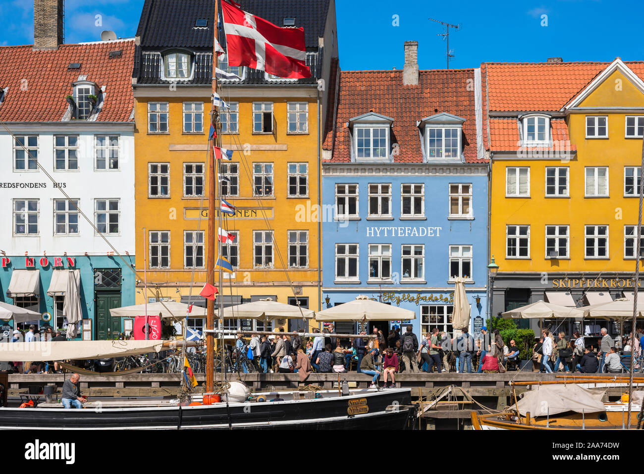Copenhagen harbor, view in late spring of colorful waterfront buildings along the busy Nyhavn quay in the harbor area of Copenhagen, Denmark. Stock Photo