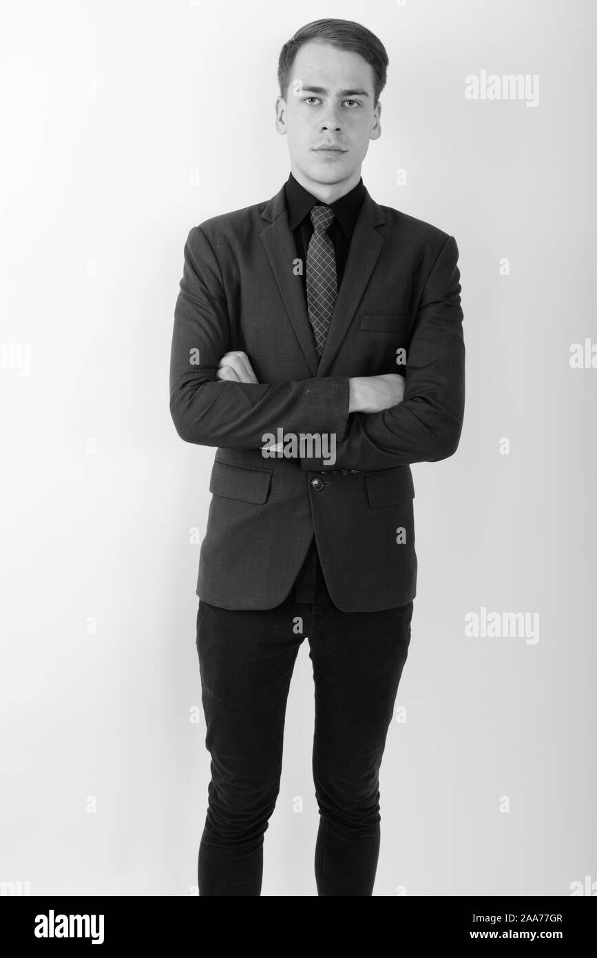 Portrait of young handsome businessman wearing suit in black and white ...