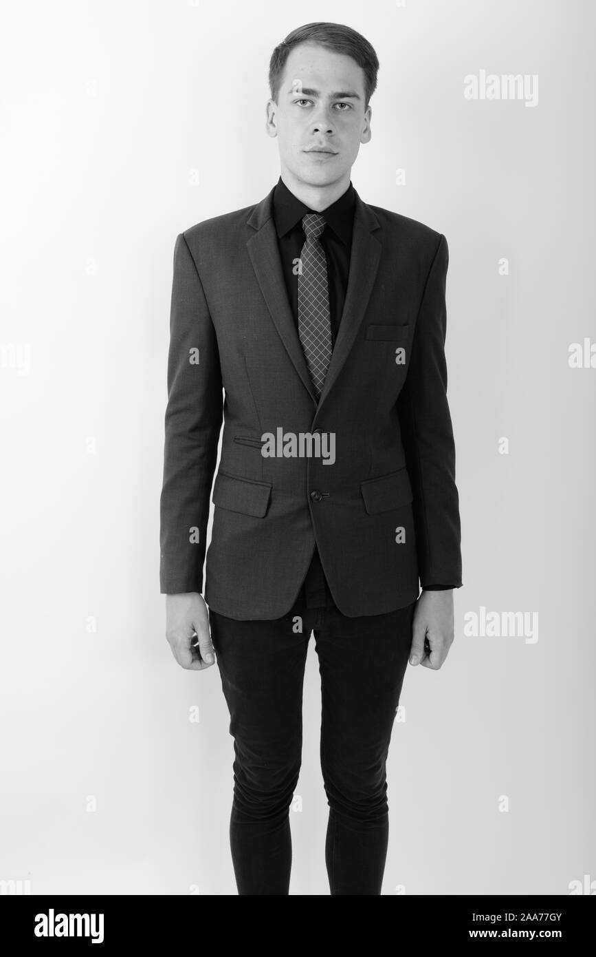 Portrait of young handsome businessman wearing suit in black and white ...