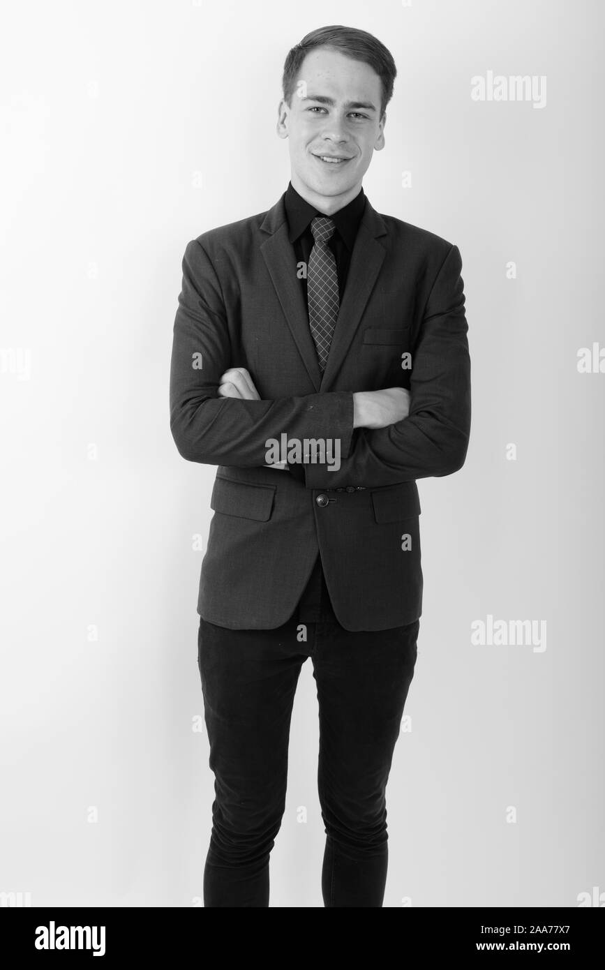 Portrait of young handsome businessman wearing suit in black and white ...