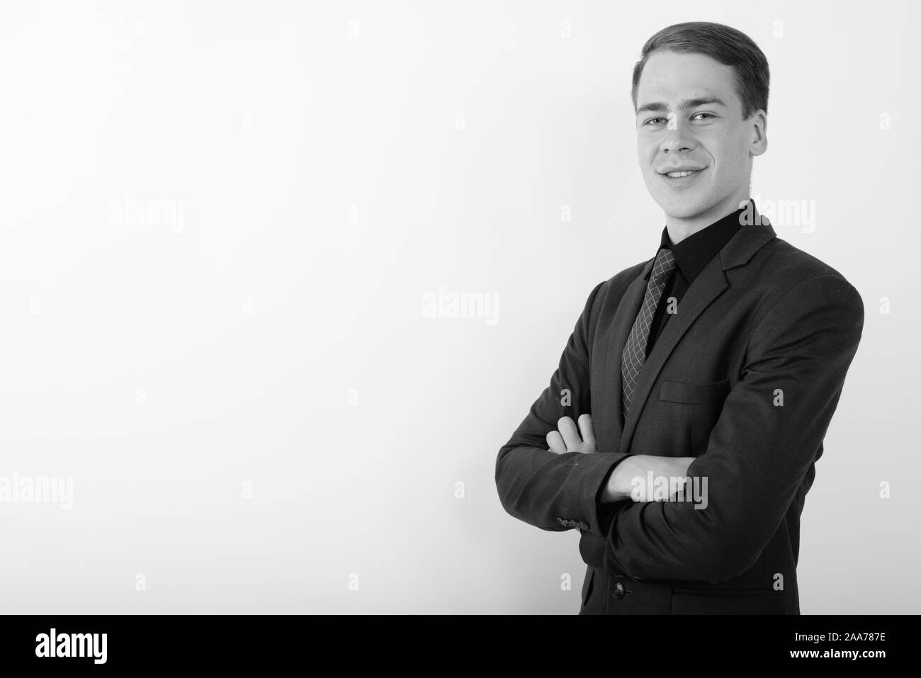 Portrait of young handsome businessman wearing suit in black and white ...
