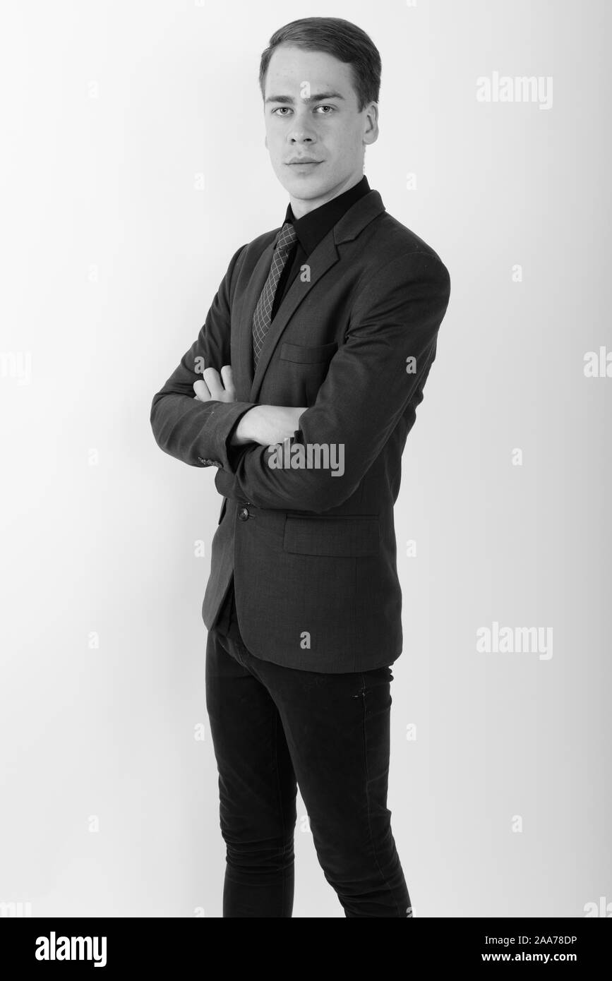 Portrait of young handsome businessman wearing suit in black and white ...