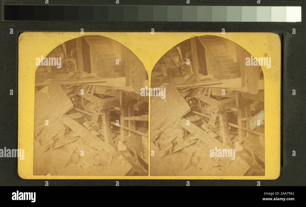 Building failure floor cave in revealing machinery below.; Building