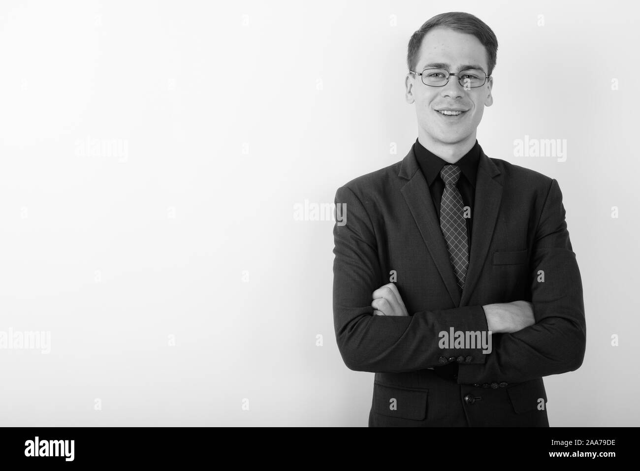 Portrait of young handsome businessman wearing suit in black and white ...