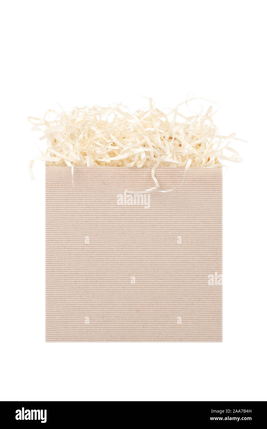 Cardboard box for eco gift filled with decorative shredded white paper/straw. Isolated on white. Stock Photo