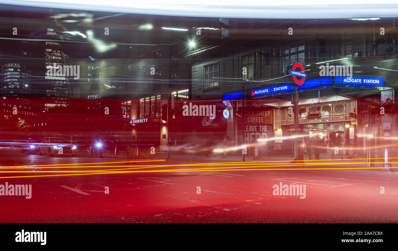 London, England, UK - November 7, 2019: A double-decker London Bus and other traffic moves along Aldgate High Street past Aldgate tube station in the Stock Photo