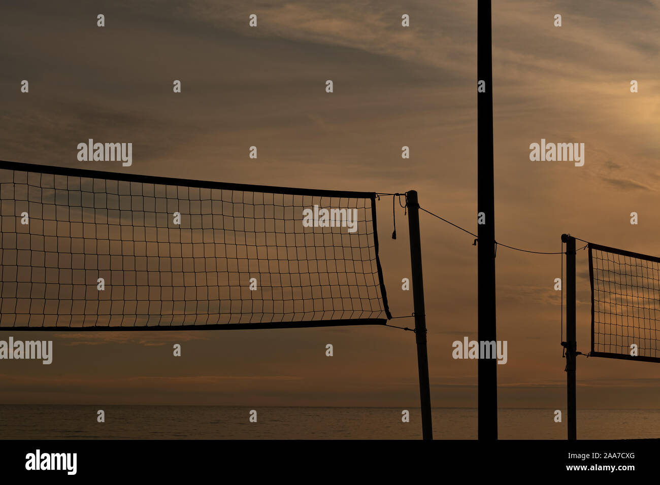 volleyball net on beach against sunset in Nerja, Spain Stock Photo