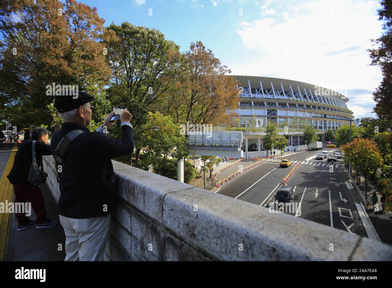 November 20, 2019, Tokyo, Japan: People take pictures of the new National Stadium which construction works has finished, according to the Japan Sport Council (JSC). Yesterday, the JSC announced the new National Stadium's facilities, including the field, seats, and pedestrian decks around the stadium, are completed and ready for council authorities' inspection on November 30. The venue is set to host the Emperor's Cup soccer final on January 1st as a first public sporting event, as well as the opening and closing ceremonies of the Tokyo 2020 Olympic and Paralympic Games. (Credit Image: © Rodrig Stock Photo