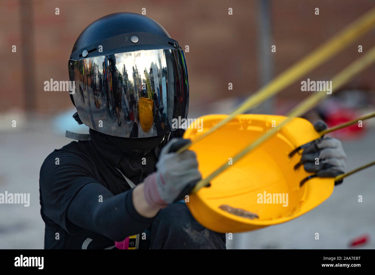 A reflection of home make sling machine seen on a helmet of a block bloc.  Siege at Polytechnic University. Police surround the university campus  after pro-democratic protesters blocked the cross-harbour tunnel and