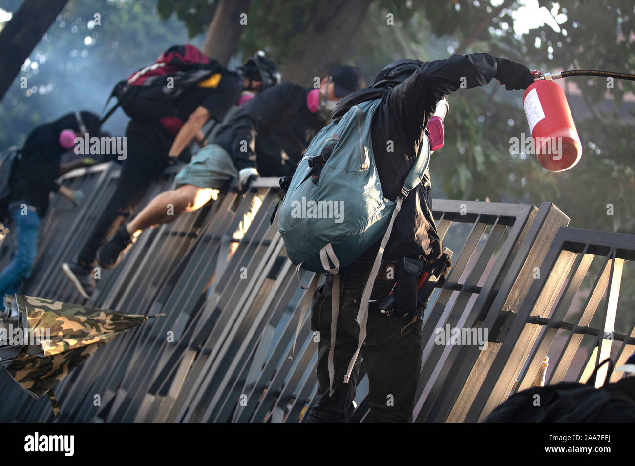 Protesters flee aways from teargas. Siege at Polytechnic University. Police surround the university campus after pro-democratic protesters blocked the cross-harbour tunnel and the major road outside the campus. Hong Kong protest continuous on its sixth months. A citywide strike called for started on Monday 11 November, 2019 which brought parts of Hong Kong to halt as MTR stations closed and multiple roadblocks were erected. Hong Kong, 18.11.2019 Stock Photo