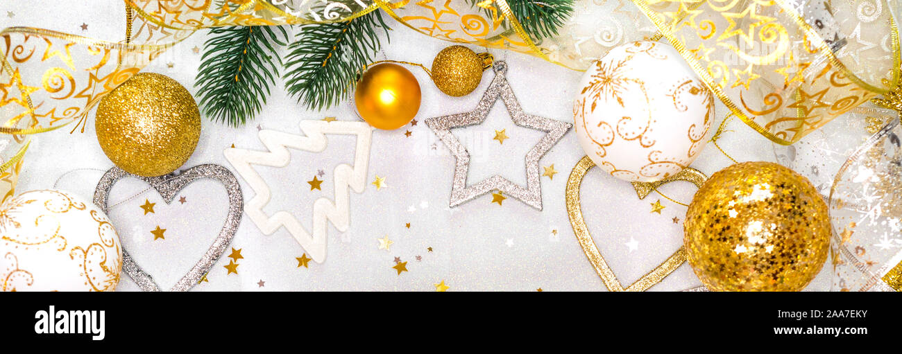 Christmas card with fir tree branch and decoration on golden glitter ...