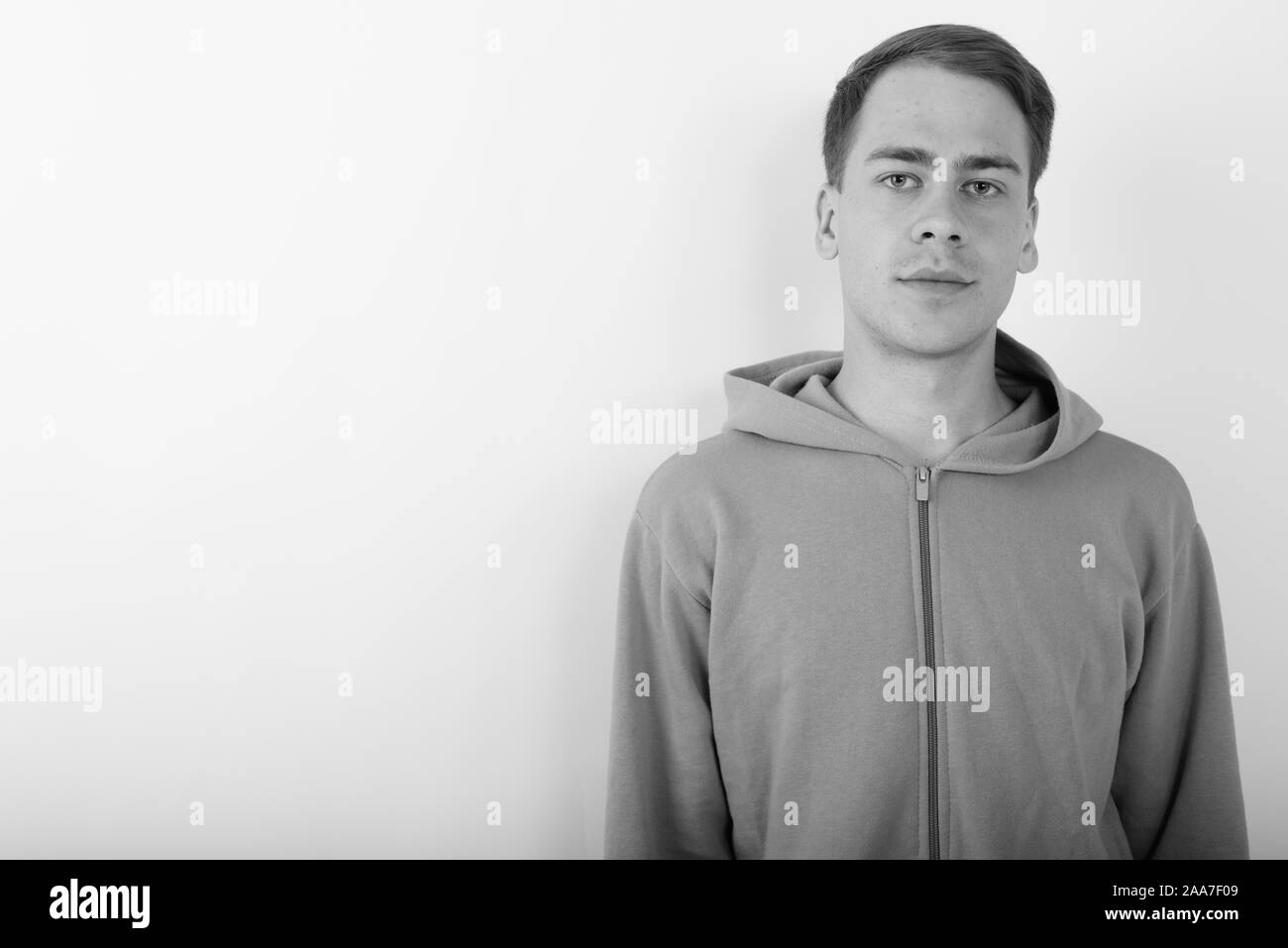 Portrait of young handsome man wearing hoodie in black and white Stock ...