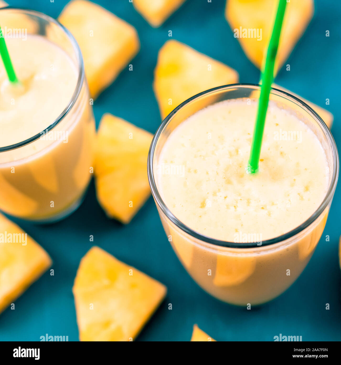 Pineapple smoothie with fresh pineapple on wooden table. Stock Photo
