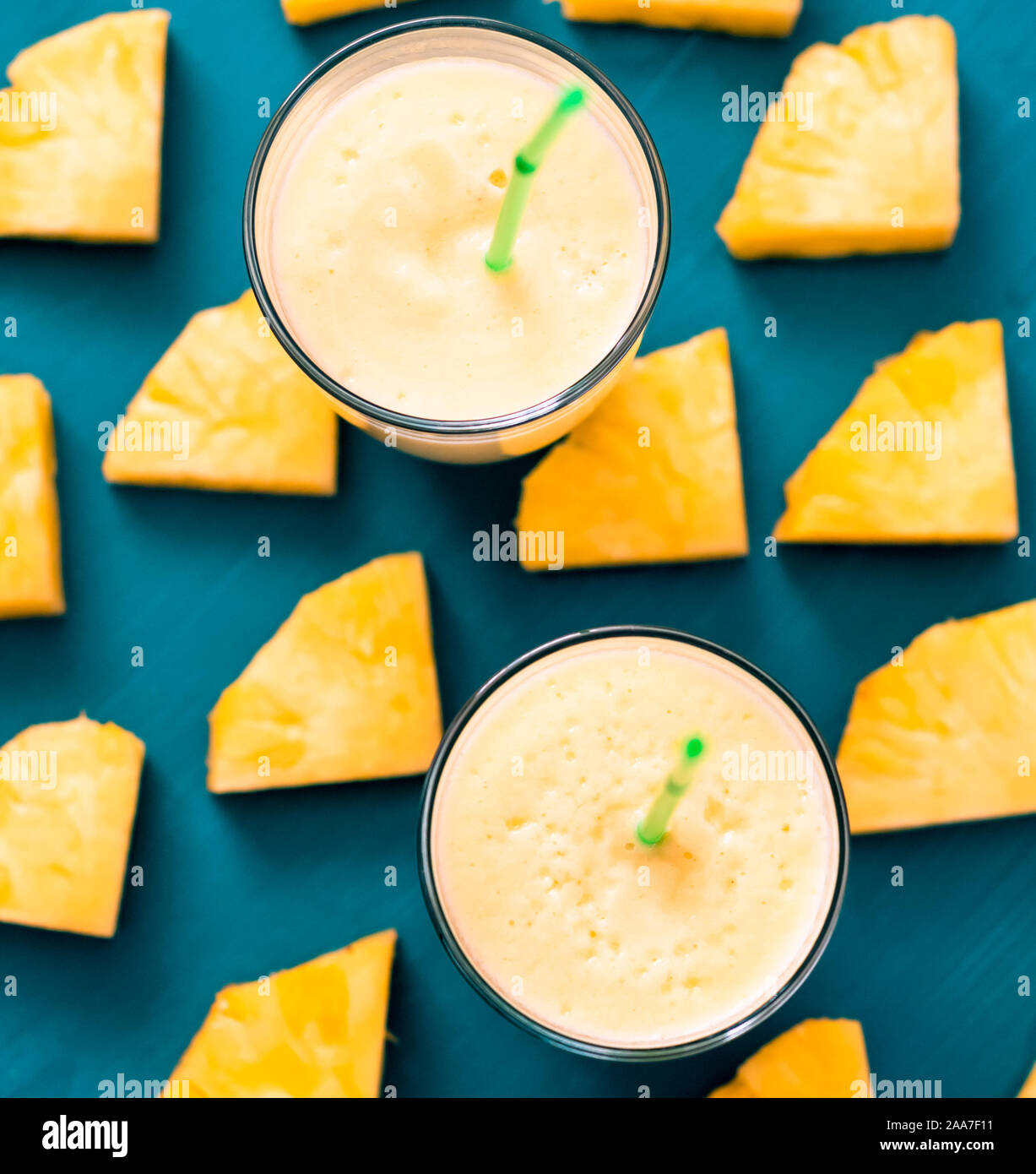 Pineapple smoothie with fresh pineapple on wooden table. Stock Photo