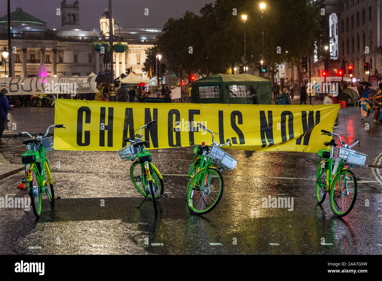 London, England, UK - October 7, 2019: Lime Bikes electric hire bikes are lined up at a road block in Trafalgar Square during Extinction Rebellion pro Stock Photo