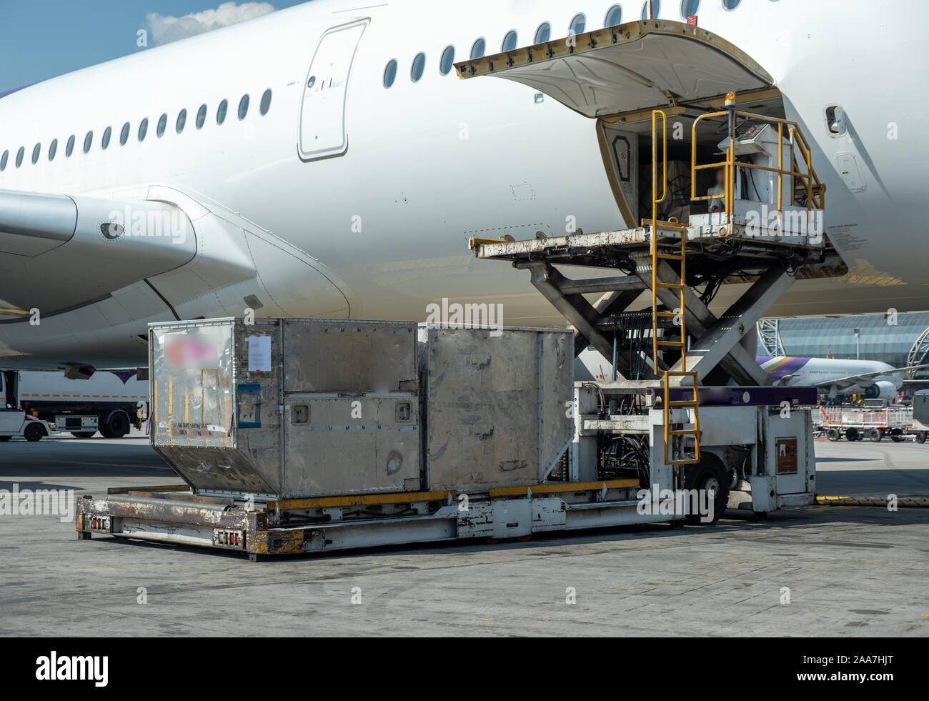 Air cargo logistic containers are loading to an airplane.Transportation and aerospace industry deliver luggage of passenger when aircraft arrive at t Stock Photo