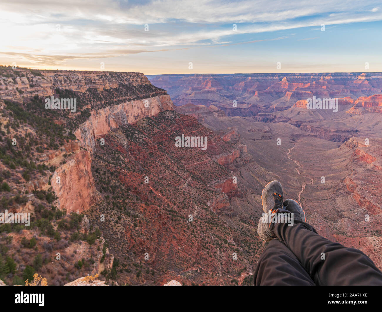 Photo of legs in hiking boots on the background of the Grand Canyon