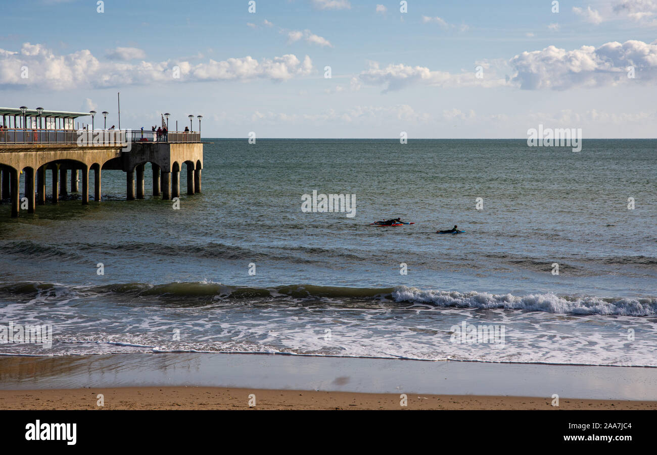 Bournemouth, England, UK - October 6, 2019: People swim in the English Channel beside Boscombe Pier on Bournemouth Beach in Dorset. Stock Photo