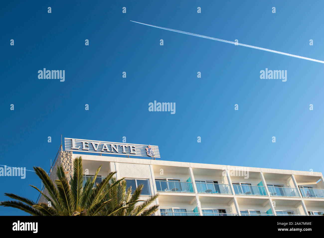 Cala Bona, Majorca, Spain, October 19, 2019, Levante Hotel with an Aircraft Trail in a clear blue sky. Stock Photo