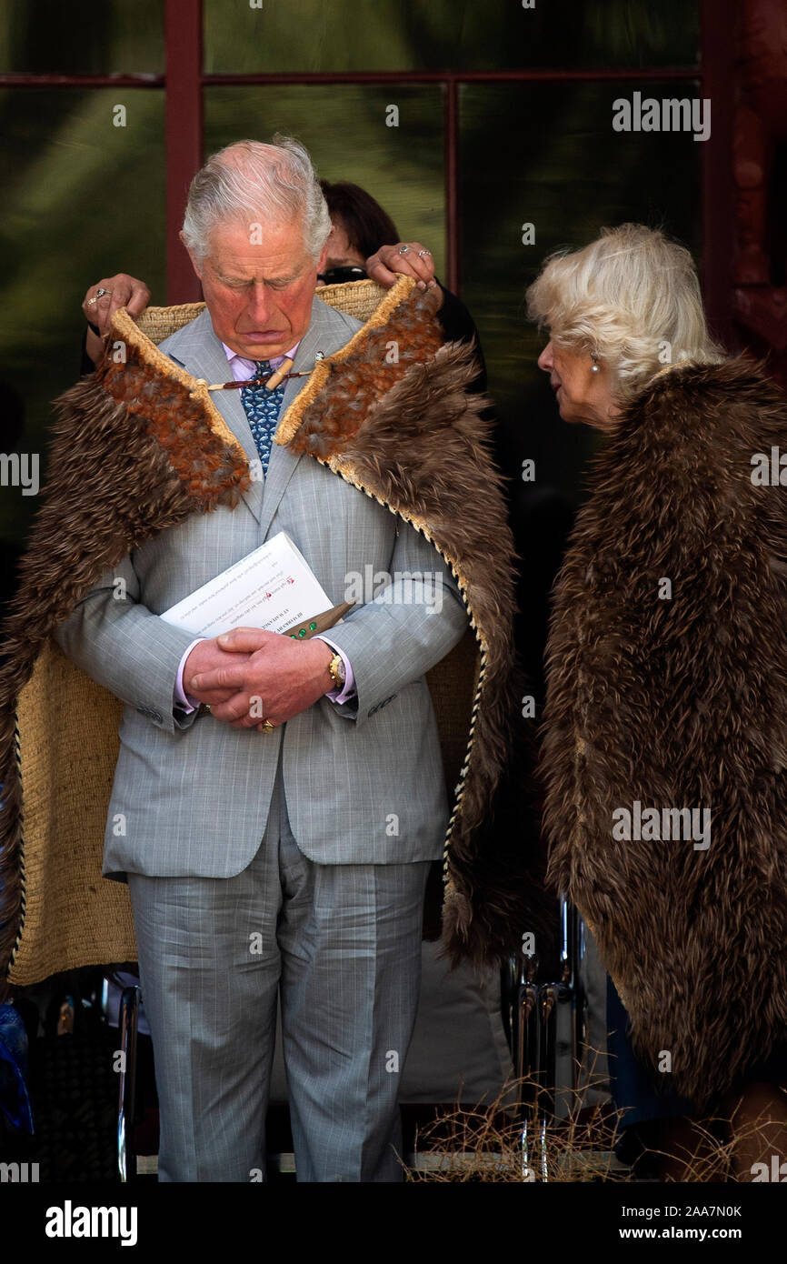 The Prince of Wales and the Duchess of Cornwall wearing Maori cloaks during their visit to Waitangi Treaty Grounds, the Bay of Islands, on the fourth day of the royal visit to New Zealand. Stock Photo