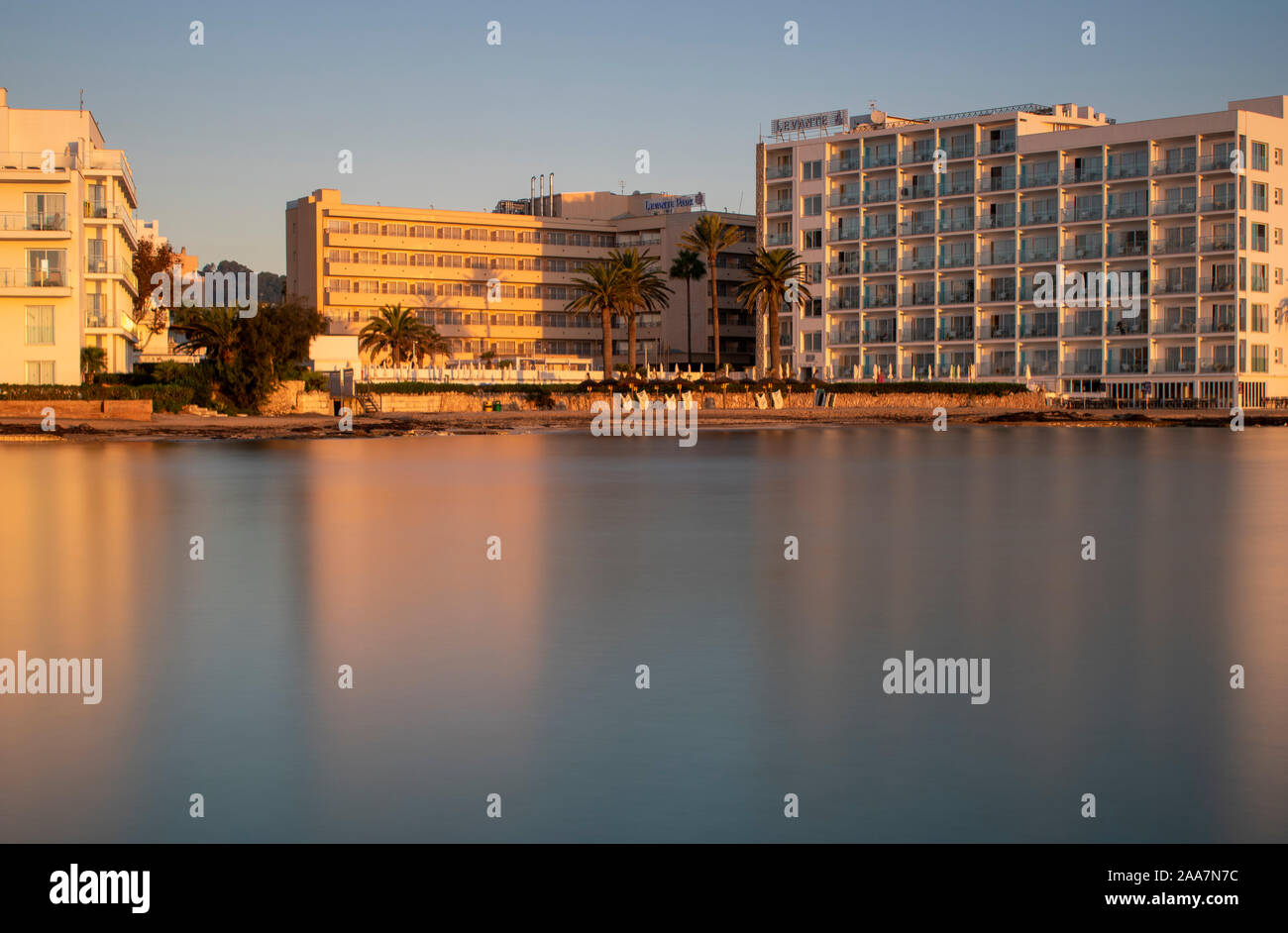 Cala Bona, Majorca, Spain, October 18, 2019, Levante Hotel from across the silky smooth bay just after sunrise. Stock Photo
