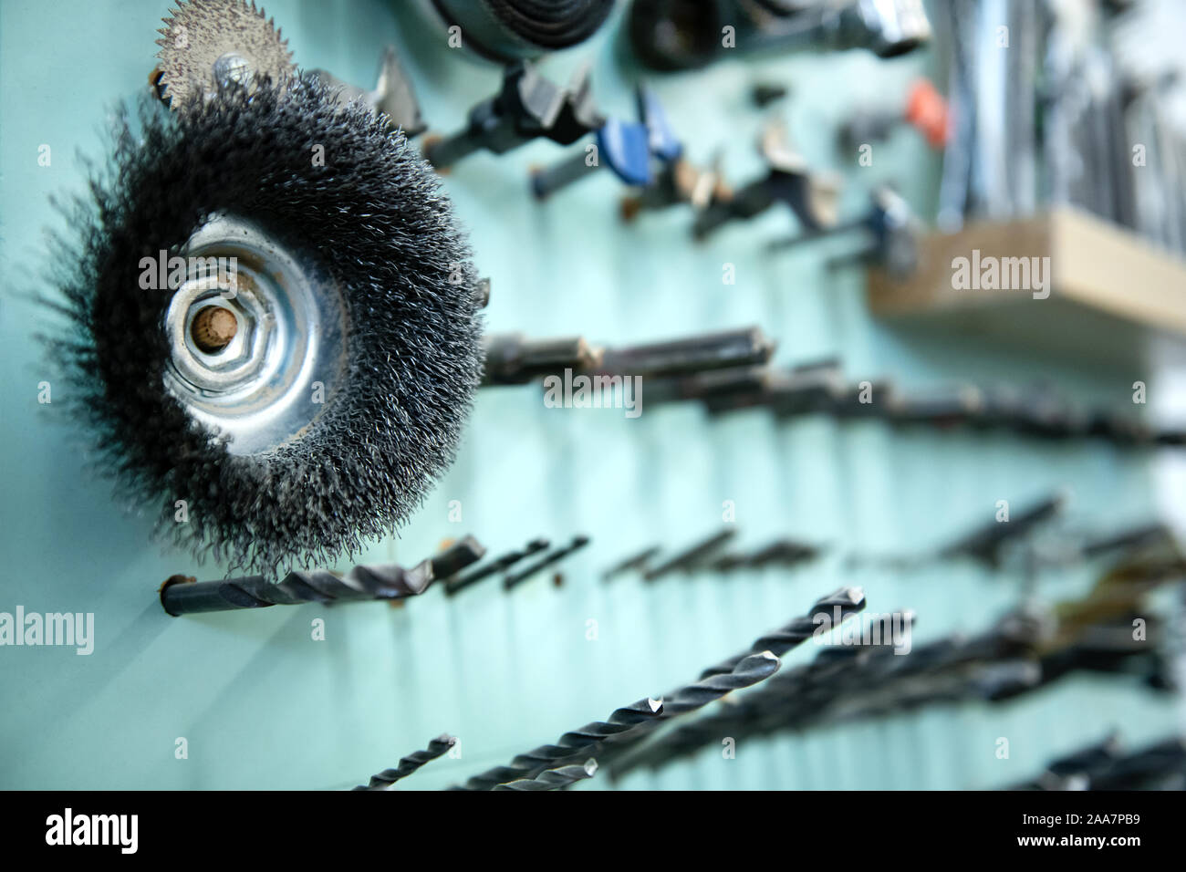 Neatly organised selection of woodworking tools on a wall in a carpentry workshop in a close up view on drill bits Stock Photo