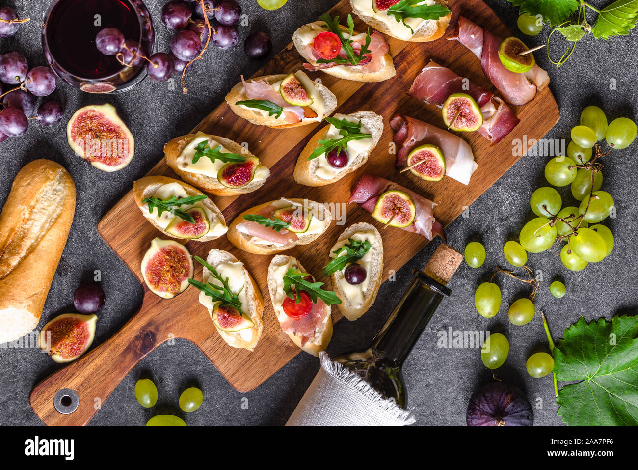 Traditional tapas bar, spanish table with food, platter with appetizers or  italian bruschetta with cheese and meat. Wine snack set Stock Photo - Alamy