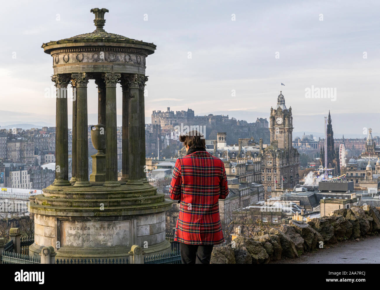 Edinburgh, United Kingdom. 20 November, 2019 Pictured: A tourist dressed in tartan takes a photograph of Edinburgh’s skyline from Calton Hill in the winter sun. Credit: Rich Dyson/Alamy Live News Stock Photo