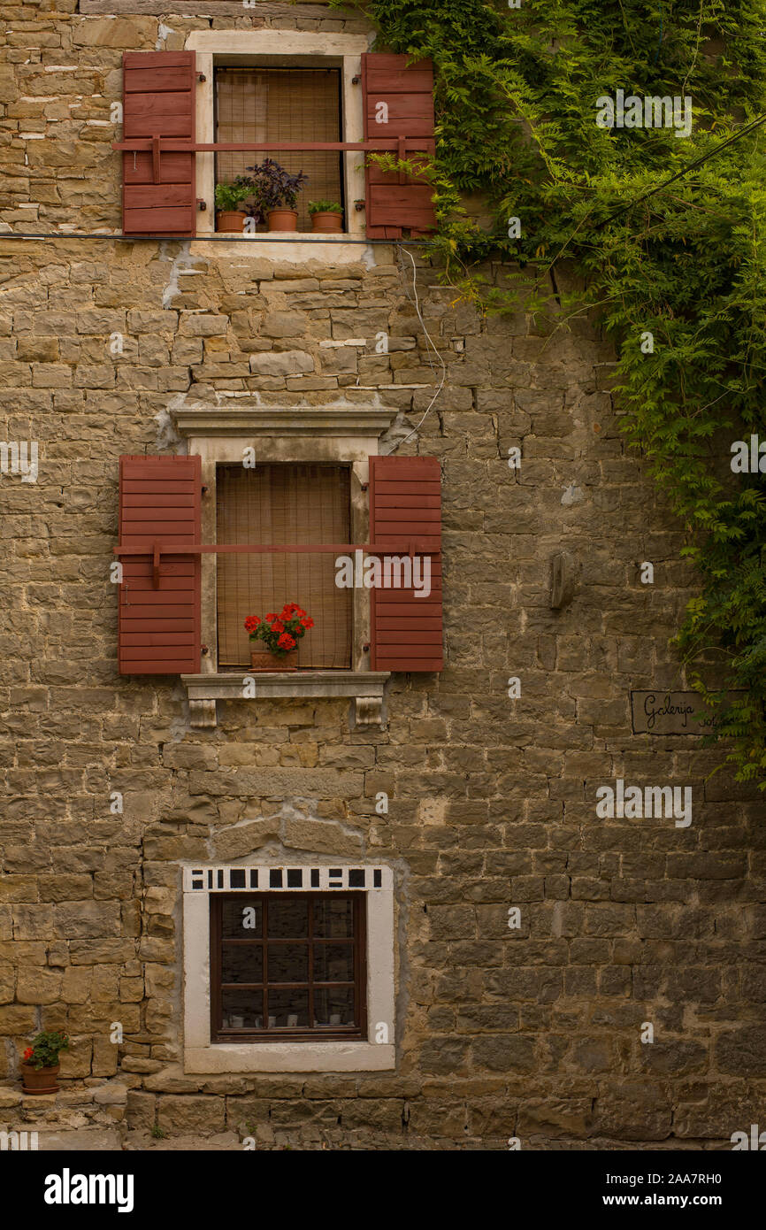 Old windows with opened shutters in stone wall Stock Photo - Alamy