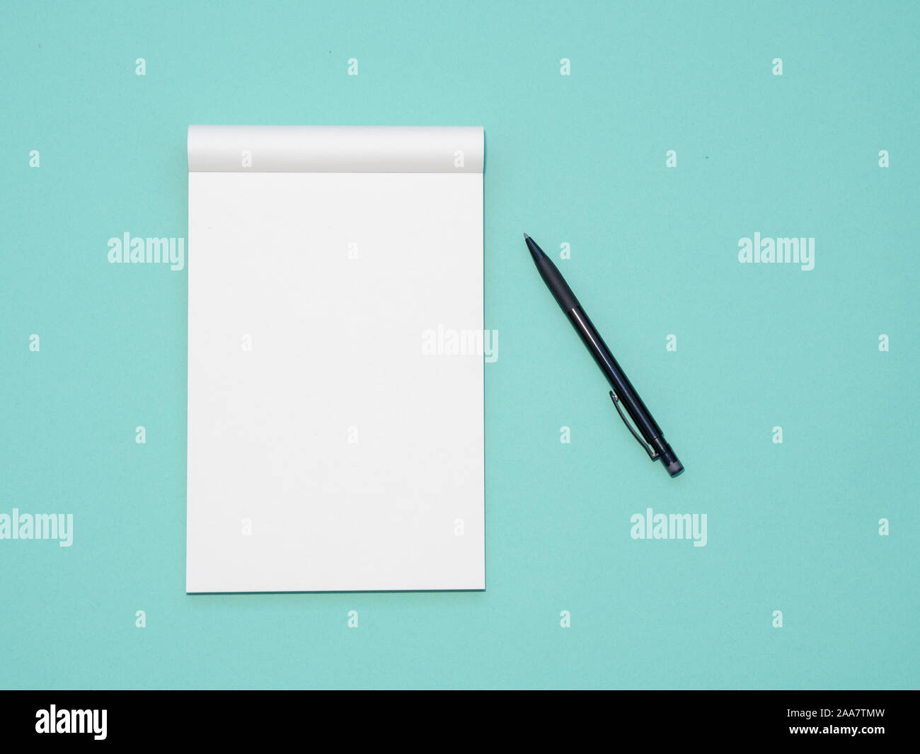 Top view workspace mockup on aqua background with open notebook and pen Stock Photo