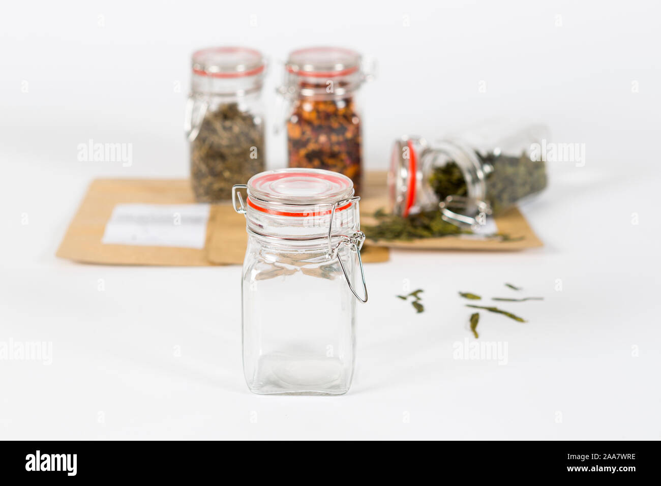 Little glass pots used for storing fresh tea, studio shot with white